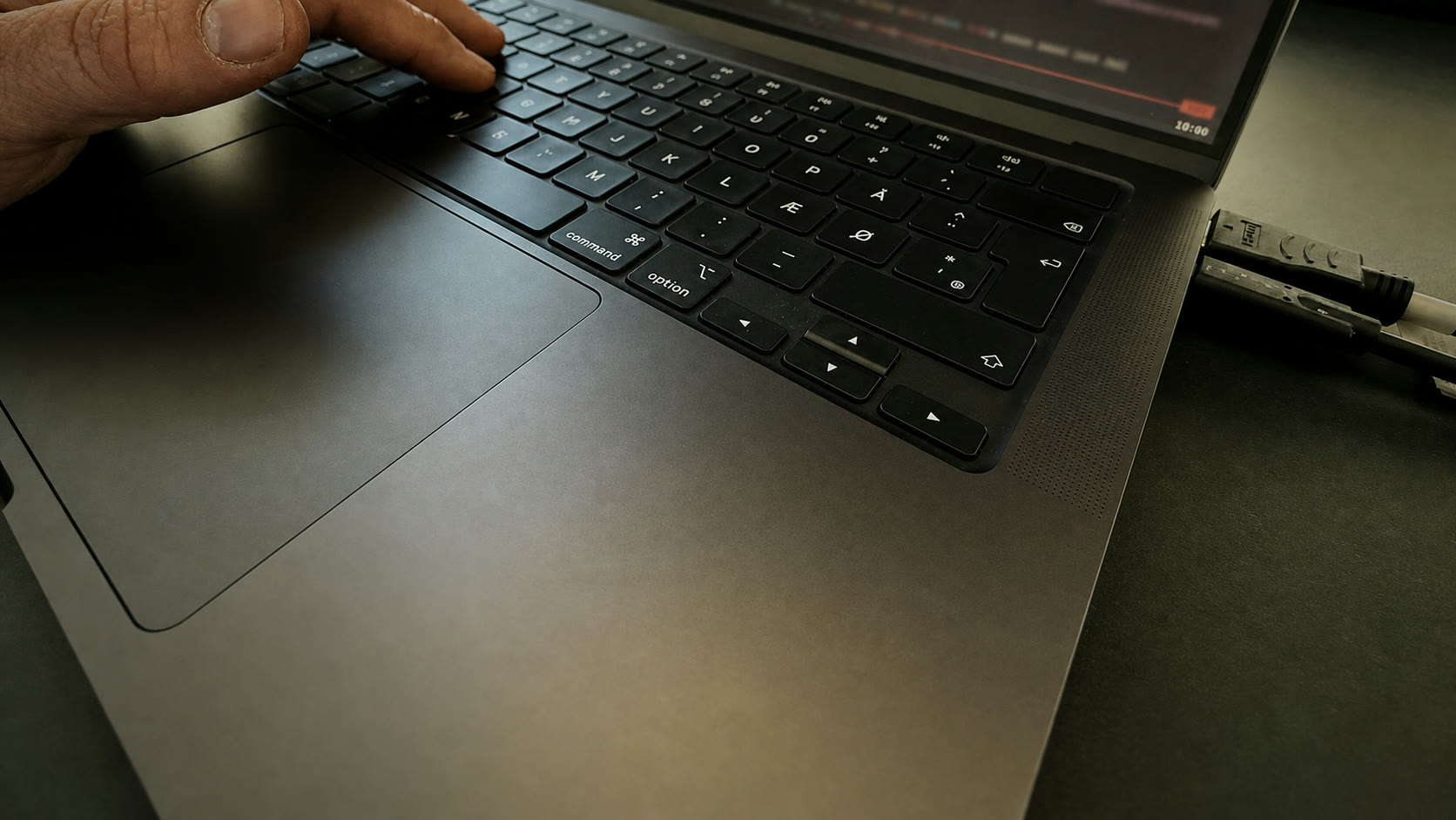 Clean close-up of a laptop keyboard and hand during a working session